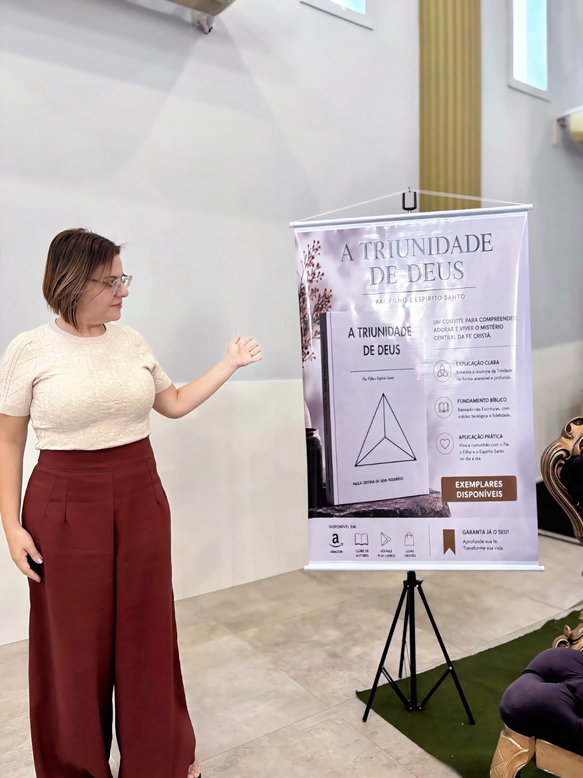 Paula Cristina apresentando o banner do livro